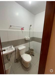 a bathroom with a toilet and a sink at Sto. Niño Whole House w/ 2 AC Bedrooms in Lucena