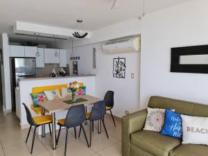 a living room with a table and chairs and a couch at Apto Frente al Mar. Vista genial al Pacífico in San Carlos