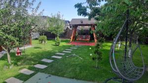 a yard with a swing set and a playground at Casa de vacanta Sabrina in Gura Humorului