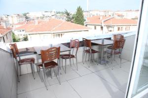 a table and chairs on a balcony with a view at Çamlıca Tower Hotel in Istanbul