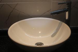 a white sink with a faucet in a bathroom at Alarga Premier Hotel in Trabzon