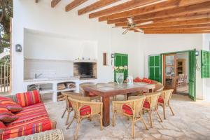 a living room with a wooden table and chairs at Wonderful 5 Bed Villa With Private in Cacla D'or