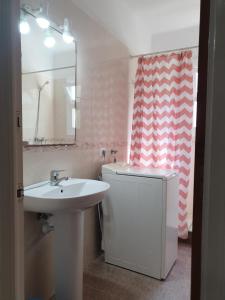 a bathroom with a sink and a toilet and a mirror at Holiday Home Villa Guapa in L'Estartit