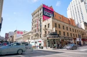 a busy city street with cars driving past a building at Herbert Hotel in San Francisco