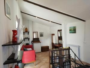 a living room with a red couch and a table at CASA LORENZO SULLE COLLINE DI LEVANTO e VICINO ALLE CINQUETERRE LT-0620 in Levanto