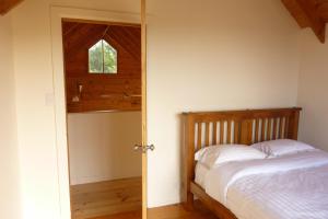 a bedroom with a bed and an open door at Charles Reuben Estate in Hobart +33 photos