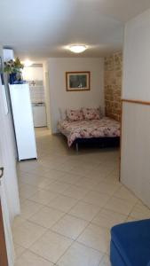 a bedroom with a bed and a refrigerator in it at Old Town Charmer in Poreč