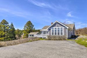 a large white house with a driveway at Charming Ocean-View Cottage By Cutler Harbor in Cutler