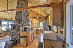 a kitchen with wooden cabinets and a stone wall at Charming Ocean-View Cottage By Cutler Harbor in Cutler