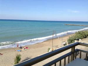 a beach with people on the sand and the ocean at Olga’s house in Cariati