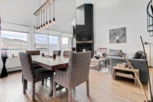 a living room with a dining room table and chairs at Hébergement Mont-Ste-Anne Condos in Beaupré