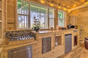 uma cozinha em chalé de madeira com um fogão e janelas em Cozy Lakeside Escape with Gas Grill and Fire Pit! em Lake of the Woods