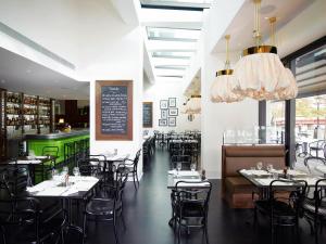 a restaurant with tables and chairs and a bar at Crown Towers Melbourne in Melbourne
