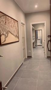 a hallway with a tile floor and a painting on the wall at Casa del Cuore in Reggio di Calabria