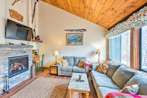 a living room with a couch and a fireplace at Loon Mountain Townhome with Pool and Slope Views! in Lincoln