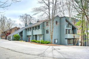 a blue house on a street at Loon Mountain Townhome with Pool and Slope Views! in Lincoln