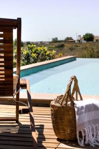 a basket sitting on a deck next to a swimming pool at Casa do Vagar in Vimieiro