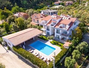 an aerial view of a house with a swimming pool at Kerem Apart Hotel in Göcek