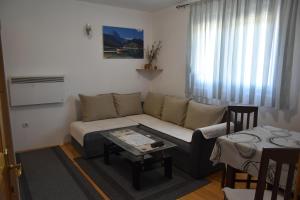 a living room with a couch and a table at Apartment VUK in Žabljak