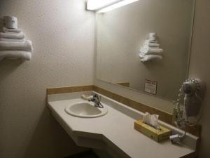 La salle de bains est pourvue d'un lavabo et d'un miroir. dans l'établissement Value Host Marquette, à Marquette