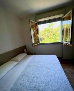 a bedroom with a large bed and a window at Hotel Nazionale in Milano Marittima