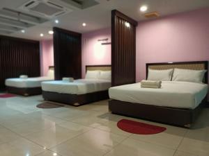 Postel nebo postele na pokoji v ubytování Hotel Sri Sutra PJ 222