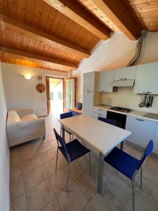 a kitchen and dining room with a table and chairs at Agriturismo Conero in Ancona