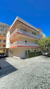 a large building with a parking lot in front of it at Apartments Neven in Omiš