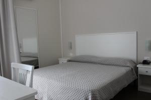 A bed or beds in a room at Hotel Corallo