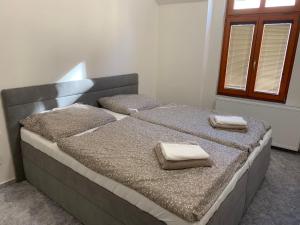 a bedroom with two beds with towels on them at Apartmány Žižkova - ideání pro firmy in Česká Lípa