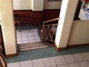 a staircase in a room with a table and chairs at GV Hotel - Camiguin in Mambajao