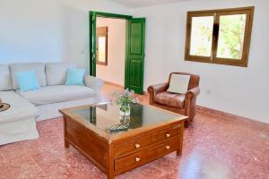 a living room with a couch and a coffee table at Casa-Finca El Maipéz de Tejeda in Las Palmas de Gran Canaria +21 photos