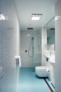 a bathroom with a toilet, sink and shower at Salamanca Wharf Hotel in Hobart