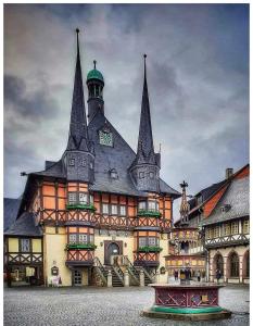 a large building with a clock tower on top of it at Apartement zum Kuckuck noch mal in Hohegeiß