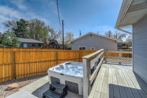 a hot tub on a deck next to a fence at NEW Modern 5BR House in Monument Near USAFA, Park in Monument