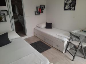 a bedroom with a bed and a desk and a chair at Apartments Ankica in Split