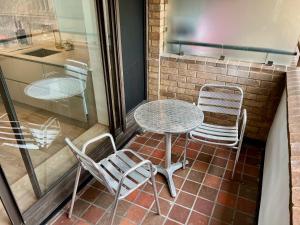 a table and chairs sitting on a patio at Thames Bankside River View City Apartment in London