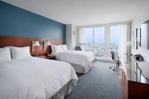 a hotel room with two beds and a large window at InterContinental San Francisco by IHG in San Francisco