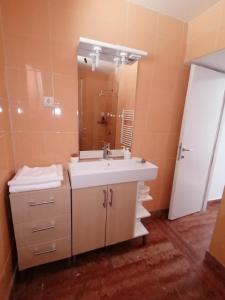 a bathroom with a sink and a mirror at APARTMANI GOMILA in Jelsa