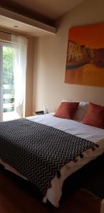 a bedroom with a large bed with a window at APARTMANI GOMILA in Jelsa