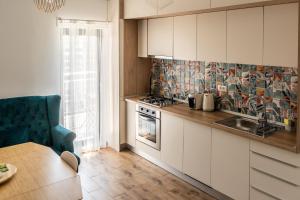 a kitchen with a sink and a stove at Cotroceni Smart Residence Studio in Bucharest