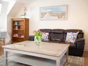 a living room with a couch and a coffee table at Ellingham Apartments, Bordeaux Harbour, Guernsey in Vale