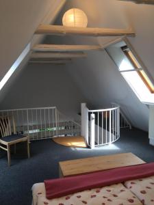 a attic room with a bed and a skylight at Ferienapartment Kastanje in Groß Ippener