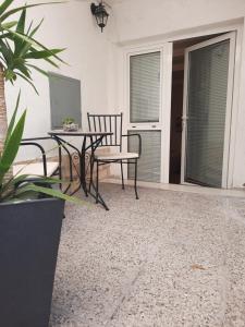a patio with two chairs and a table and a screen at Apartments Ankica in Split