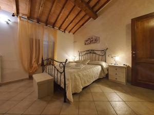 a bedroom with a bed and a dresser and a window at Appartamenti Tinacci in San Gimignano