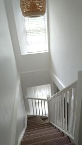 a stairway with a window and a stair case at Lincombe Court Apartment Wellswood Torquay in Torquay