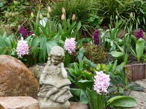 a statue of a little girl in a garden with flowers at Stadtvilla-Apartment mit Parkblick und bester Verkehrsanbindung in Bremerhaven