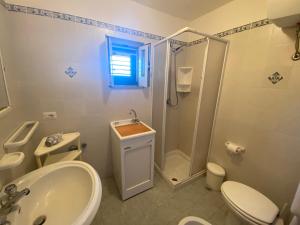 a bathroom with a sink toilet and a shower at Fiordaliso - Holiday Housing in Lipari