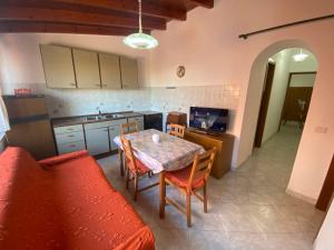 a kitchen with a table and a kitchen with a couch at Fiordaliso - Holiday Housing in Lipari +23 photos