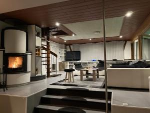 a living room with a couch and a fireplace at Traumscheune mit Pool, Kamin und privatem Spa in Linnich